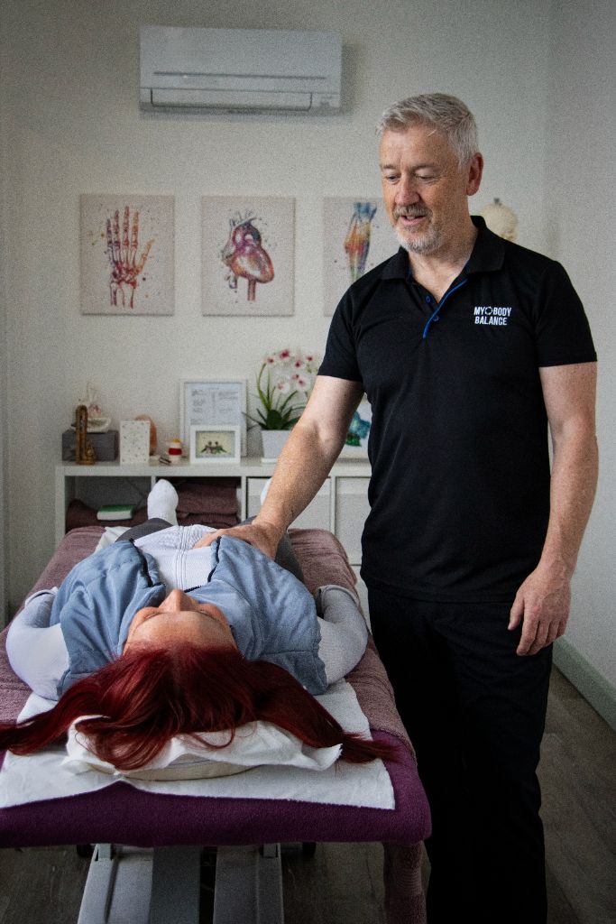 Therapist working with a client on a treatment table